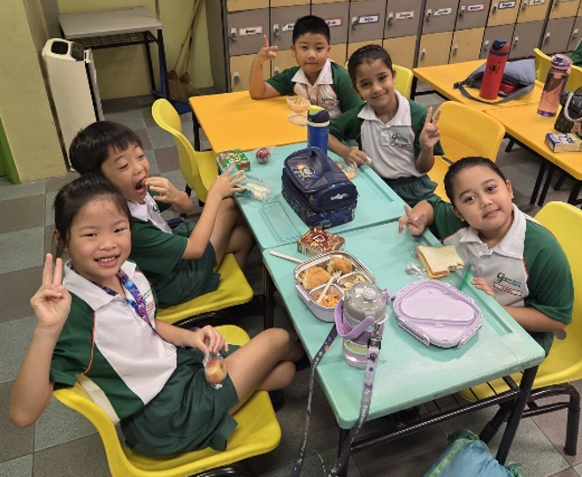 Students enjoying breakfast together in the school classroom.